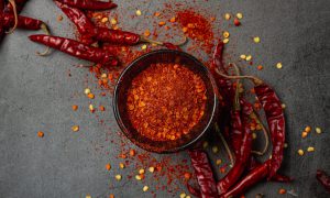 Red chilli paste on a black background.